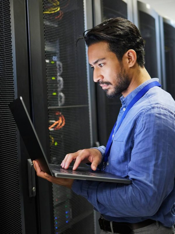 programming-data-center-and-a-man-with-a-laptop-for-maintenance-cyber-security-and-internet-check.jpg